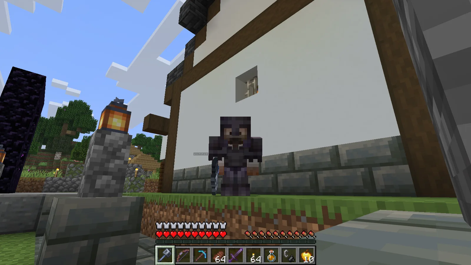The suited man in full Netherite armor holding his newly crafted Mace in the village