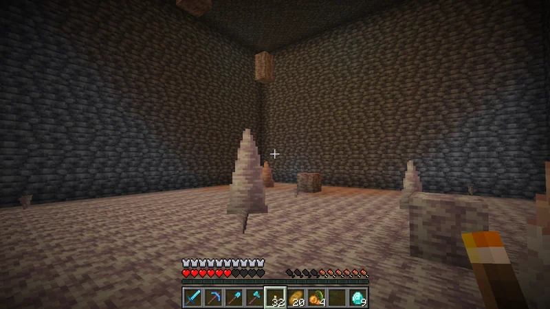 Pointed dripstone in a deep underground cave Pointed dripstone in a deep underground cave