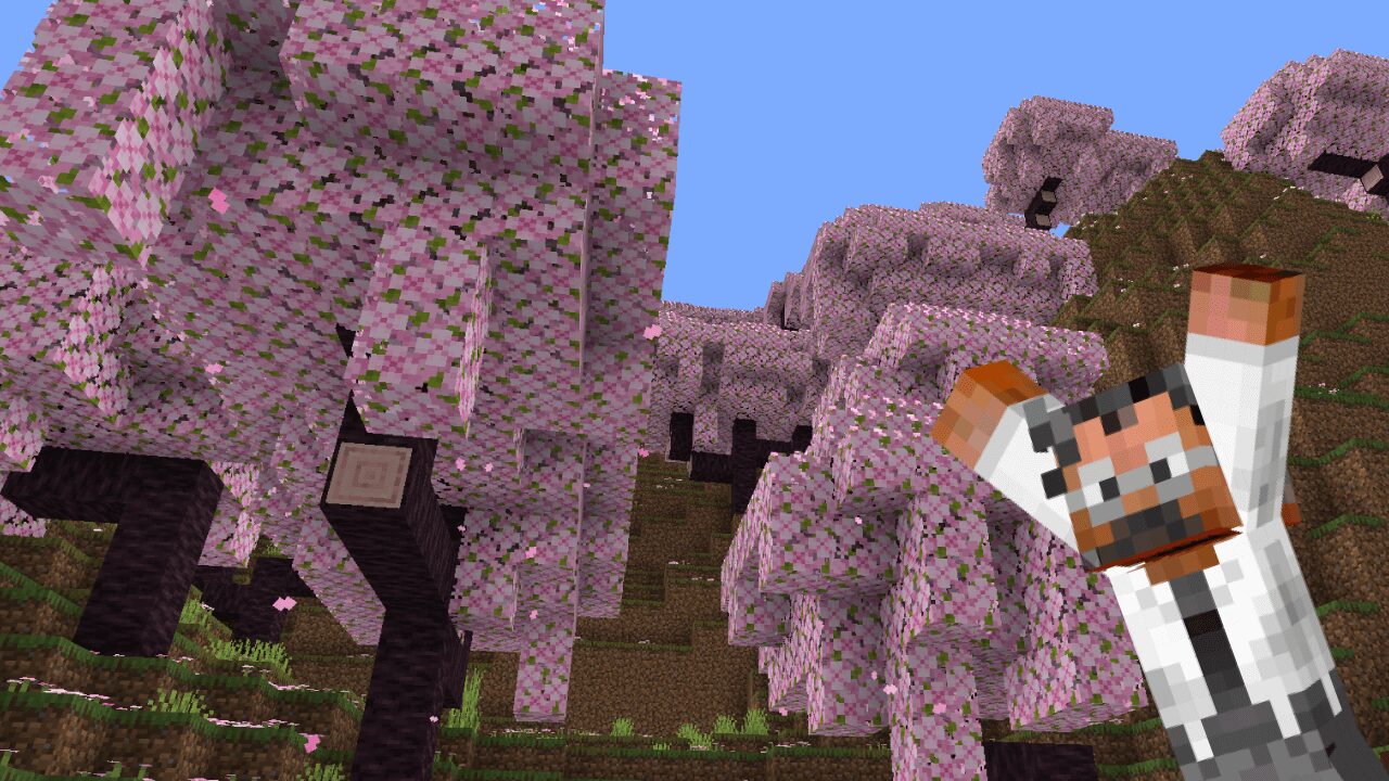 The suited man standing among blooming cherry trees