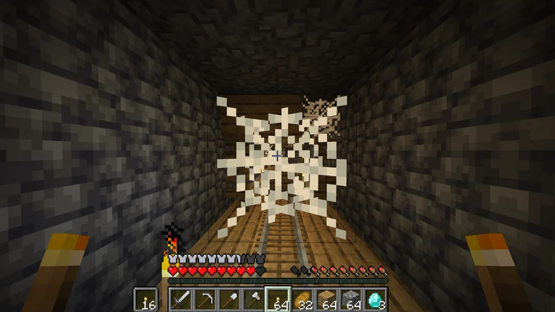 A mineshaft passage with rails and cobwebs ahead A mineshaft passage with rails and cobwebs ahead