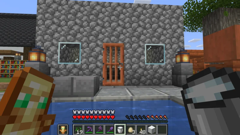The completed cake shop with cobblestone walls, glass windows, and an acacia door