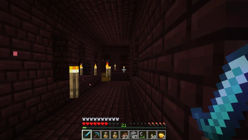 A long Nether Fortress corridor marked with torches along the route A long Nether Fortress corridor marked with torches along the route