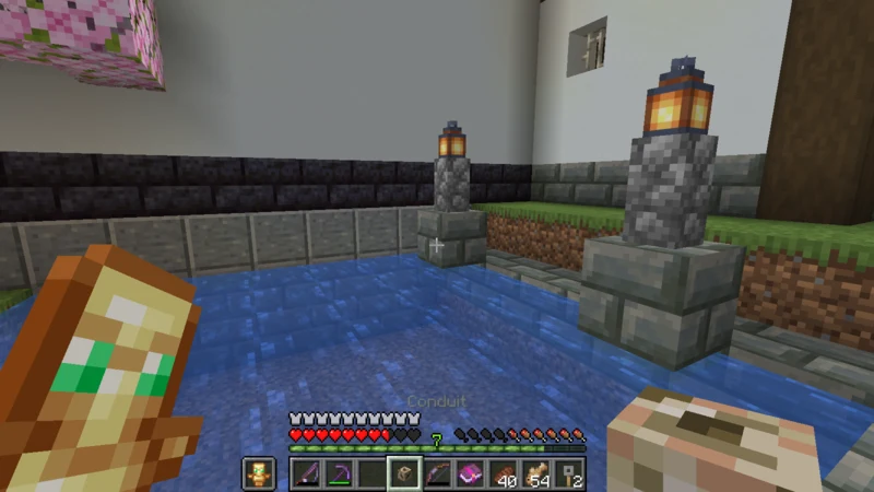 Holding the finished conduit beside the fishing pond and its lanterns Holding the finished conduit beside the fishing pond and its lanterns