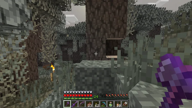 Chopping pale oak with an axe beside hanging moss Chopping pale oak with an axe beside hanging moss