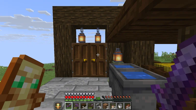The closed wooden gate with double doors and hanging lanterns The closed wooden gate with double doors and hanging lanterns